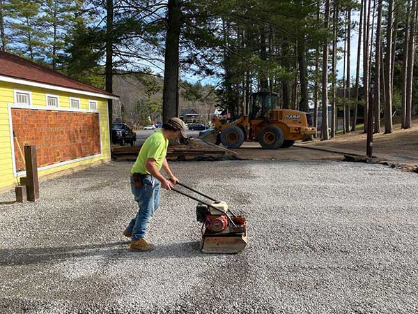 Stormwater Control and Green Infrastructure Project District Technician Lenny Croote tamps down the final stone layer for an H 20 rating to hold vehicles
