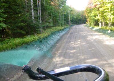 Hydroseeding a drainage ditch from the back of a truck